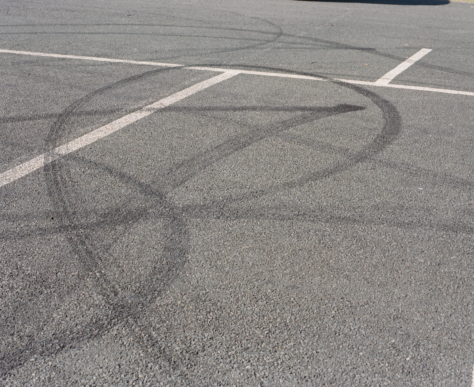 Remnants of Fun - 2025 — Tyre marks across a car park
